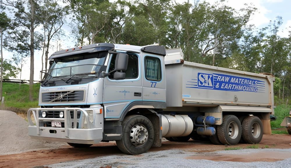 A Dump Truck Is Parked On The Side Of The Road — S & K Raw Materials & Earthmoving in Atherton, QLD