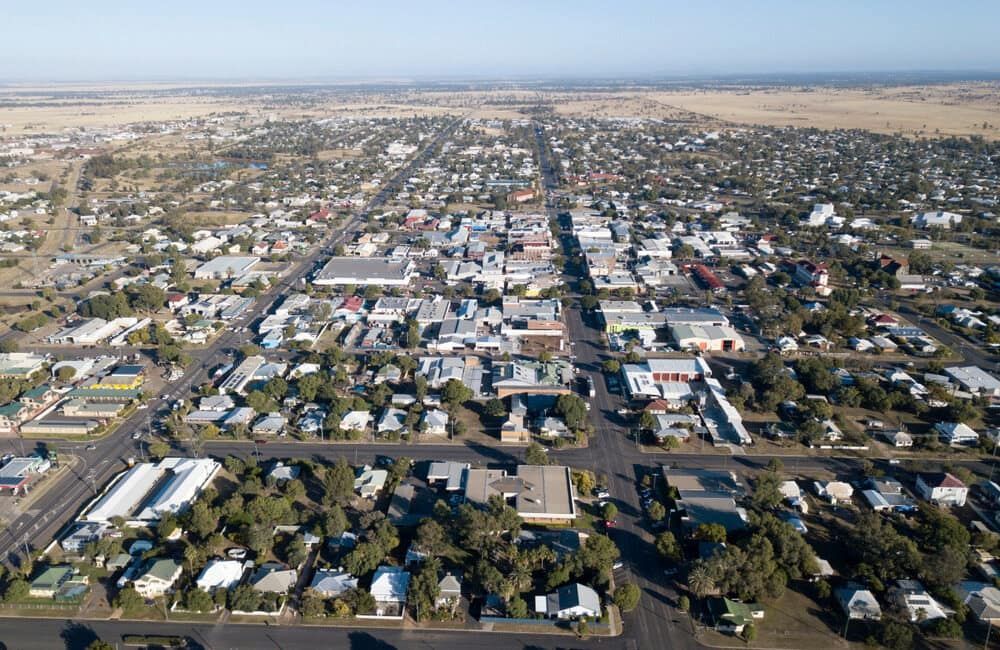 An Aerial View Of A City With Lots Of Buildings And Trees — S & K Raw Materials & Earthmoving in Georgetown, QLD