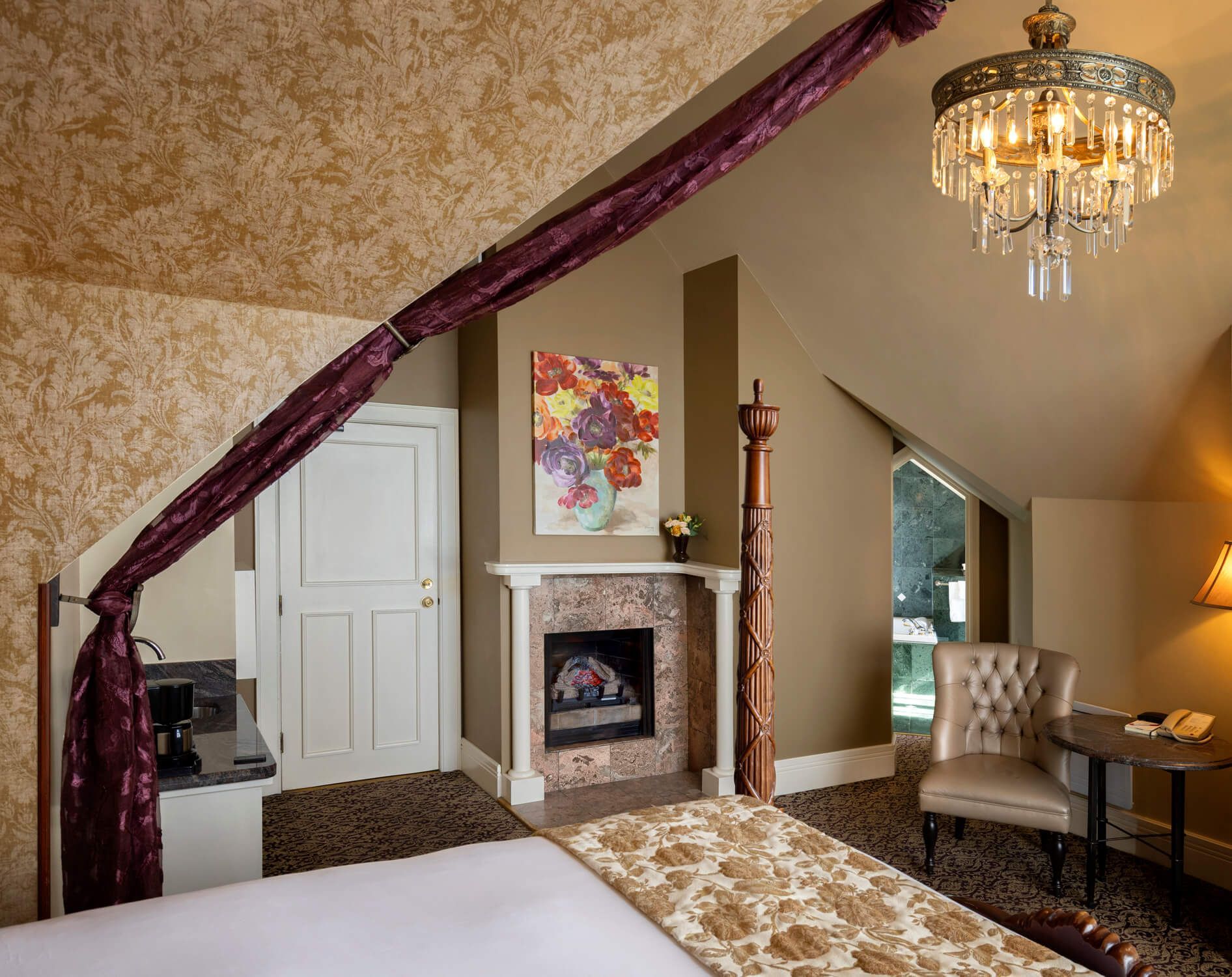 A bedroom with a canopy bed and a fireplace