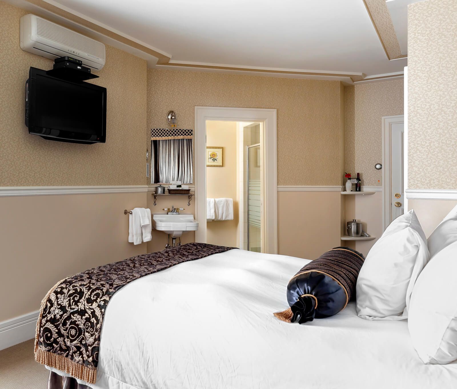 A hotel room with a large bed and a flat screen tv