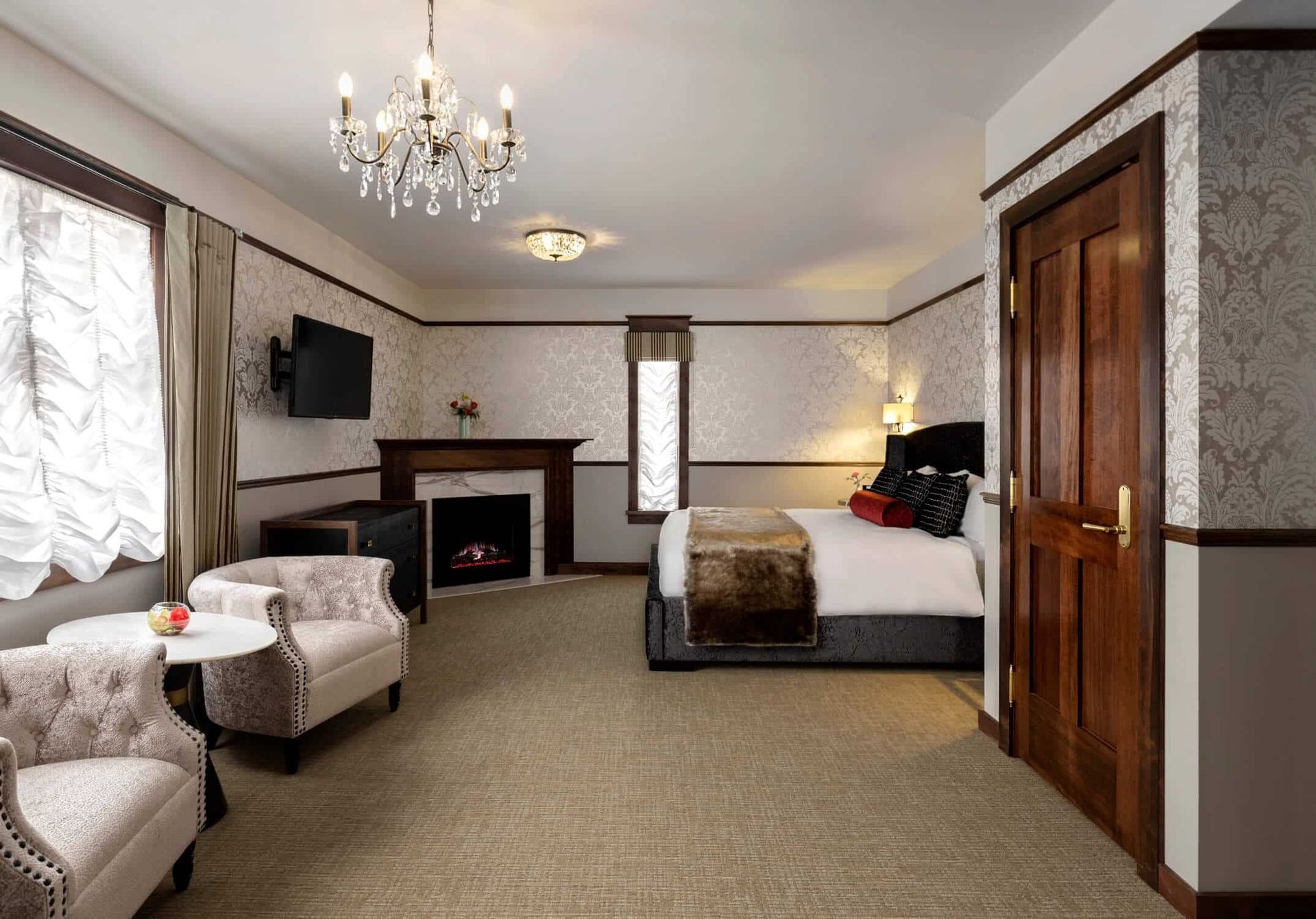 A hotel room with a large bed and a fireplace