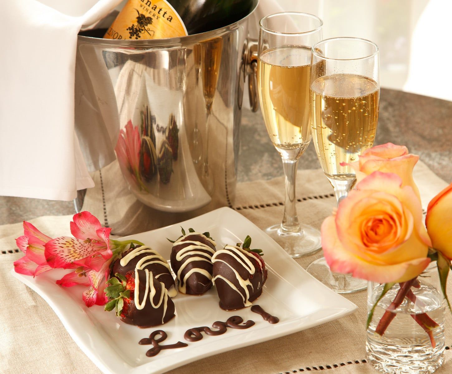 A plate of chocolate covered strawberries with the word love written on it