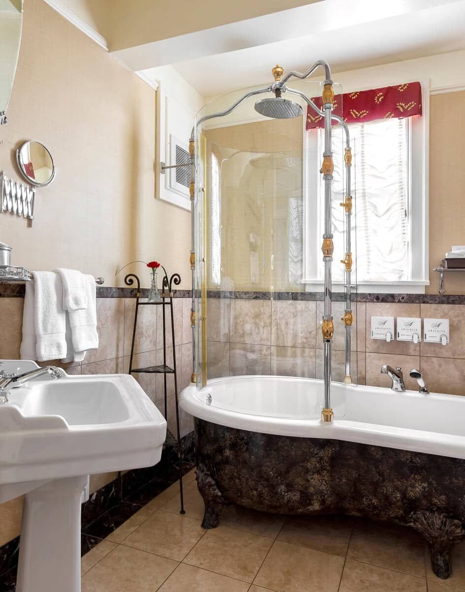 A bathroom with a tub , sink and shower