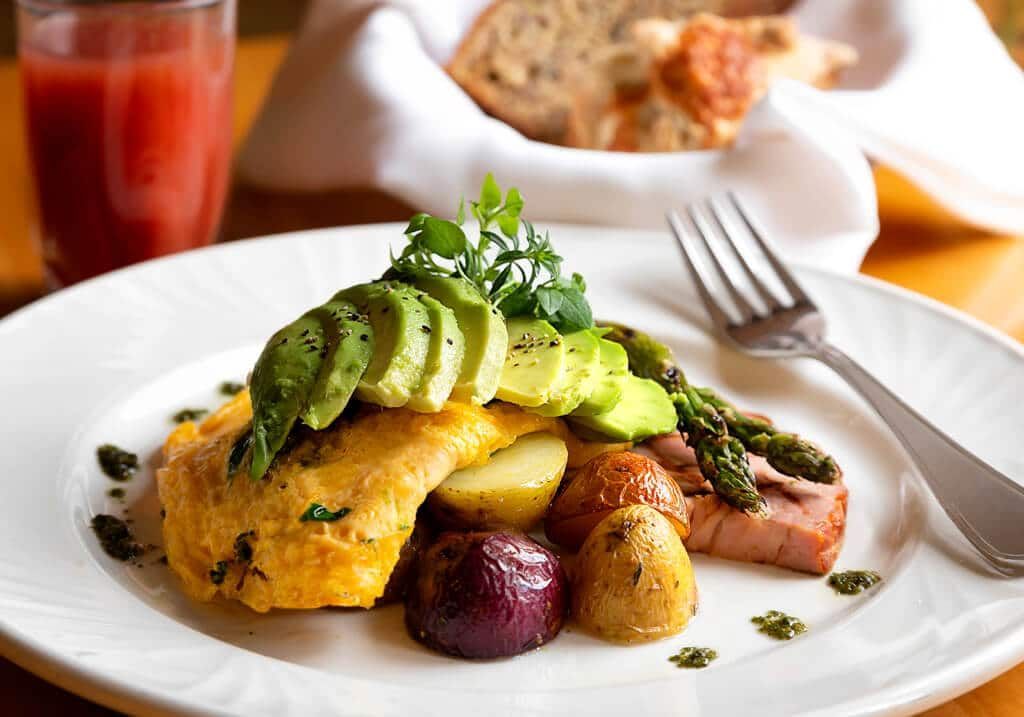 A plate of food with a fork on a table