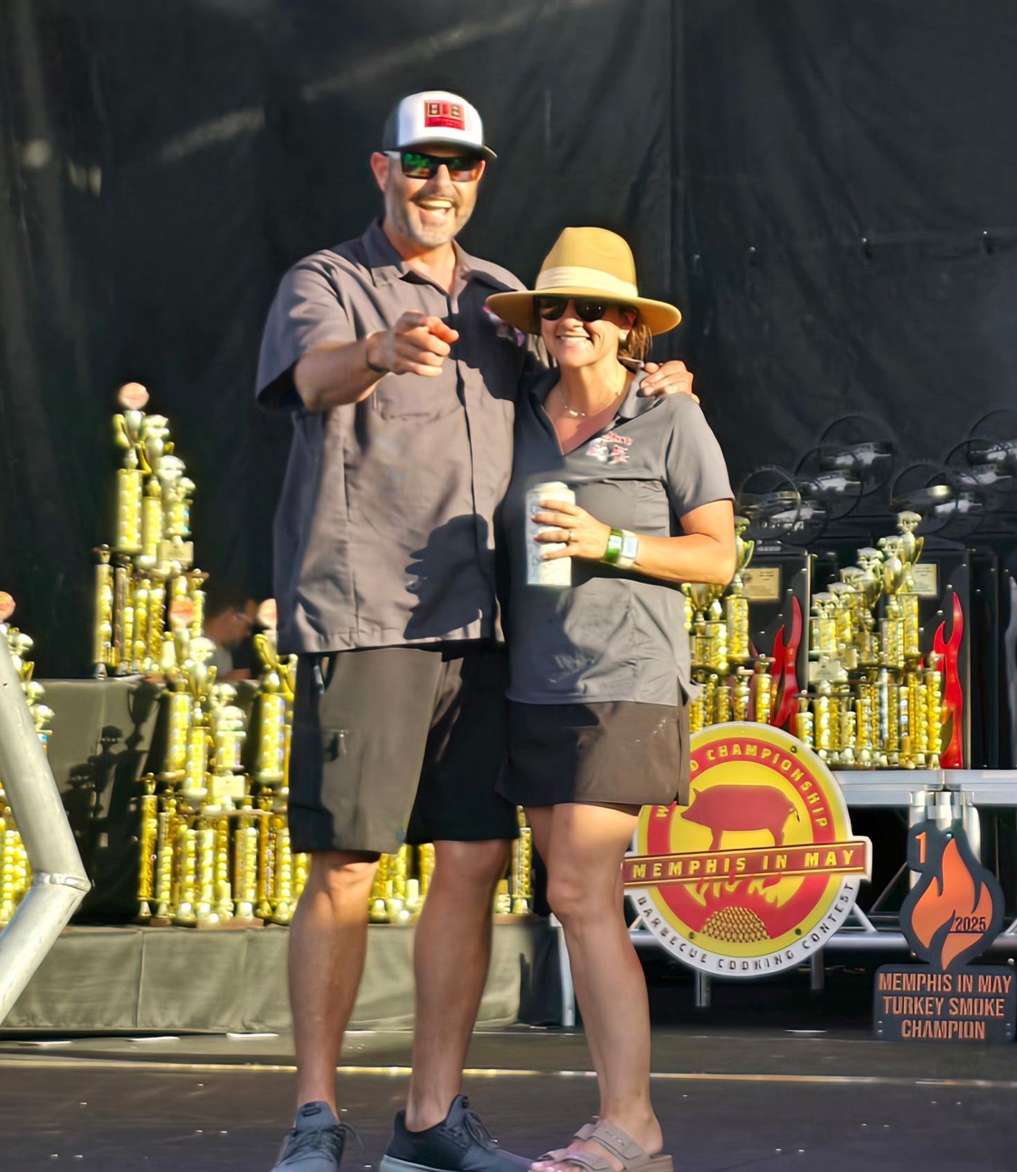 B&B Team pitmaster Adam Gautreau on a stage with trophies 