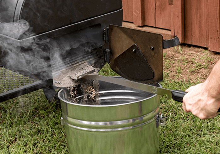Cleaning ash from a pellet grill into a bucket