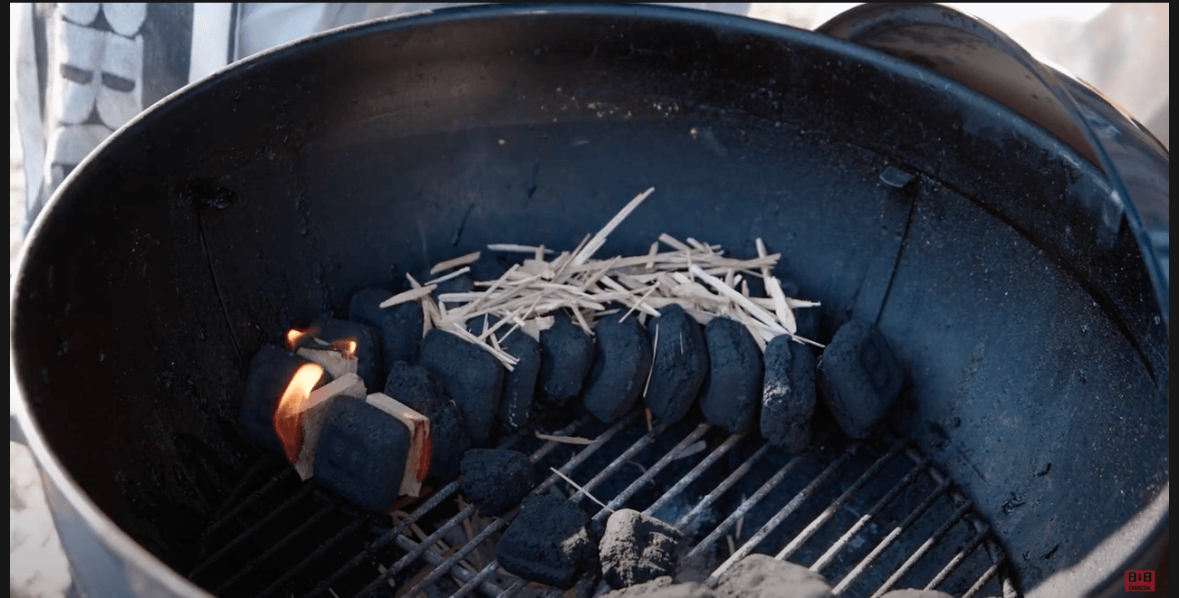 snake method arrangement of briquets and wood chips in grill