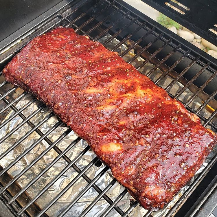 Glazed spareribs cooking on the grill