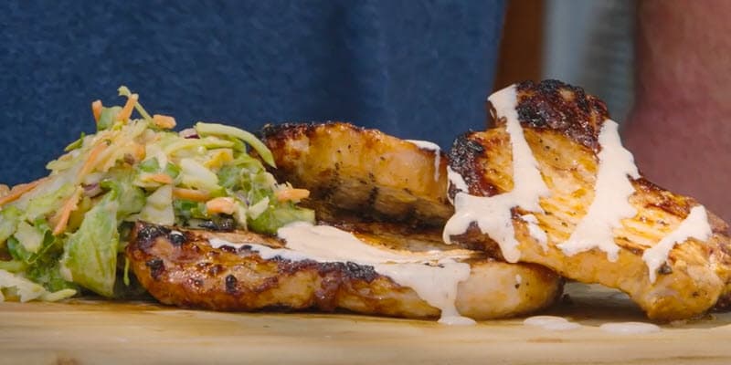 grilled pork chops topped with alabama white sauce