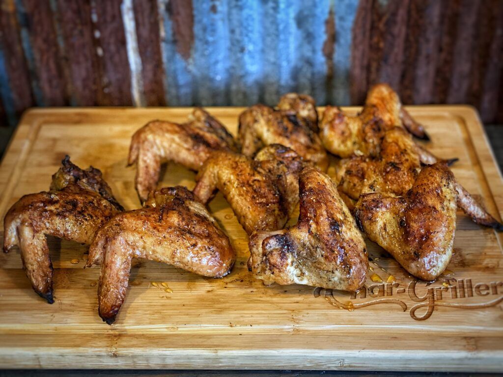 Grilled Chicken Wings with honey on a cutting board