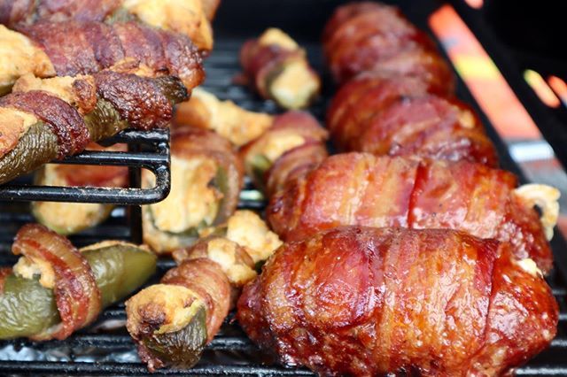 Bacon wrapped jalapeno poppers cooking on the grill