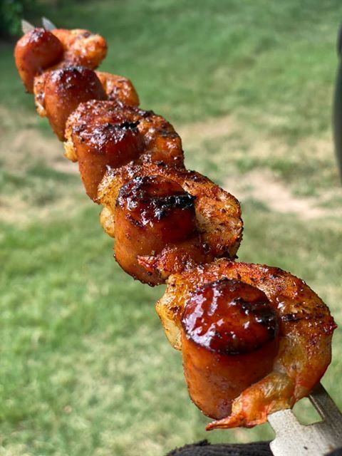 Skewer of grilled sausages encased with shrimp