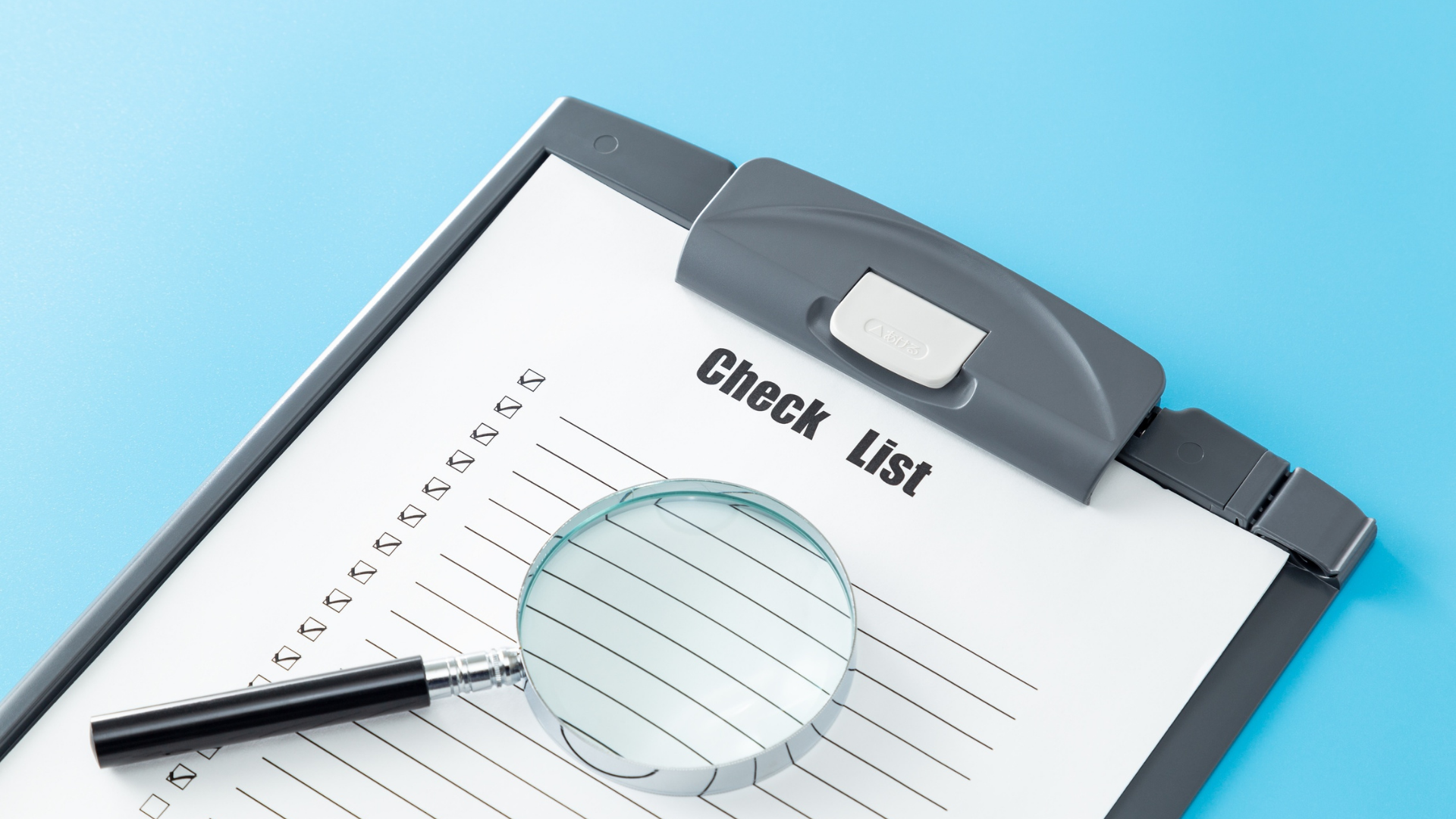 Clipboard with checklist and magnifying glass on blue background.