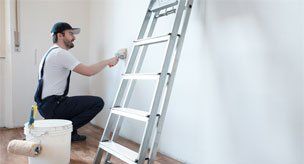 Interior Re-Painting — Man painting walls inside the house in Carson City, NV