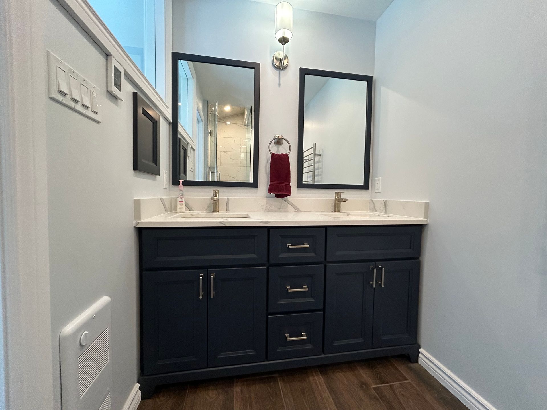 A bathroom with two sinks and two mirrors.