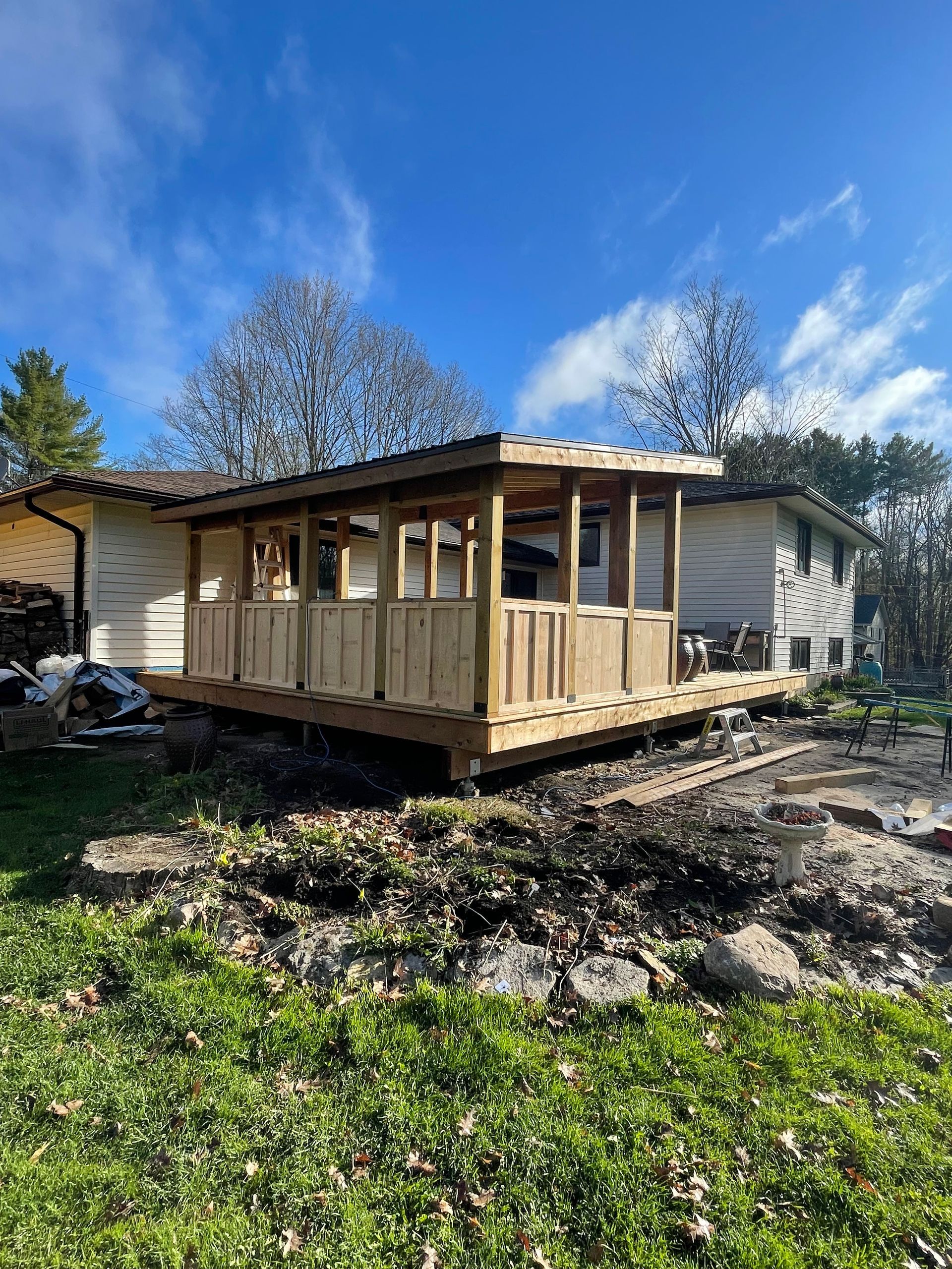A house is being moved to a new location with a wooden deck.