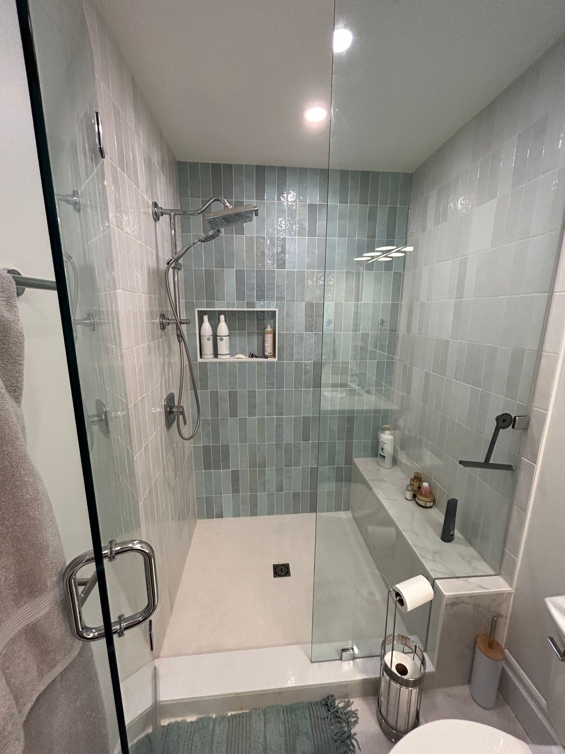 A bathroom with a walk in shower and a toilet.