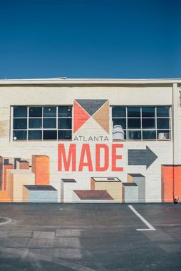 A mural on the side of a building that says made