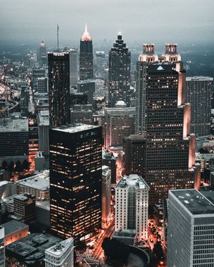 An aerial view of a city at night with lots of tall buildings