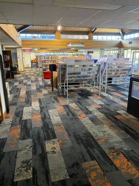 Library Interior With Book Displays on a Patterned Carpet Floor — Ozwide Flooring In Ciccone, NT