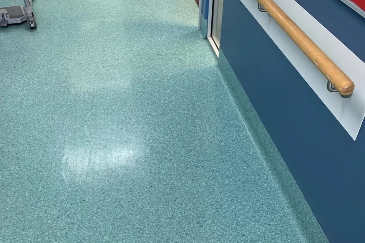 Blue and Teal Speckled Floor, a Blue Wall With a White Stripe, and a Wooden Handrail — Ozwide Flooring In Ciccone, NT