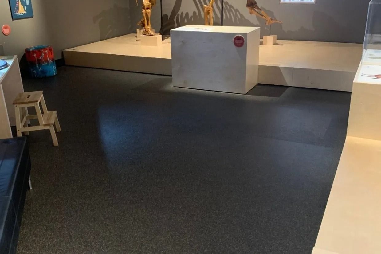 Museum Exhibit With Display Platforms, Sculptures, and a Dark Floor — Ozwide Flooring In Ciccone, NT