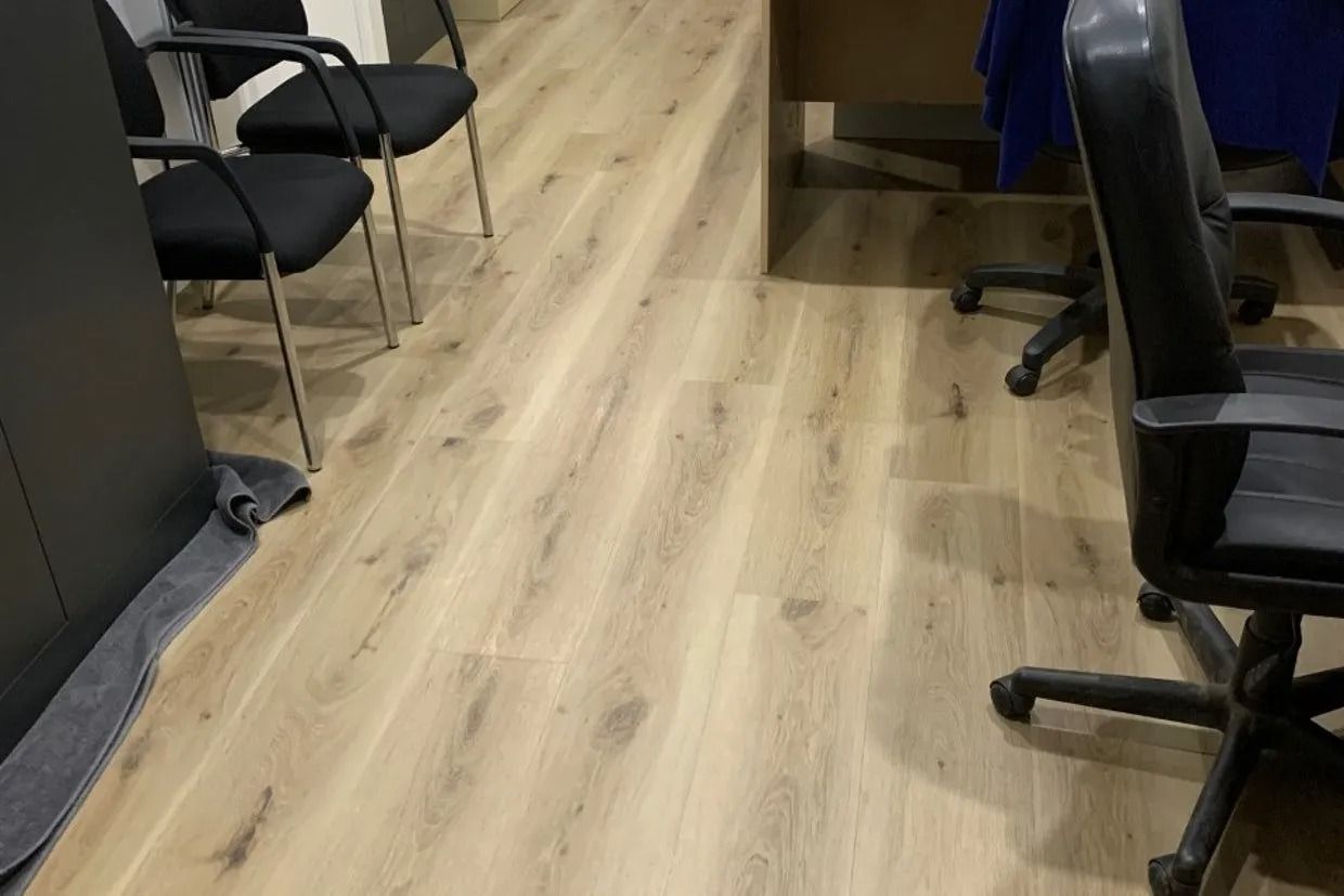 Office Floor With Light Wood-look Laminate and Black Chairs Visible — Ozwide Flooring In Ciccone, NT
