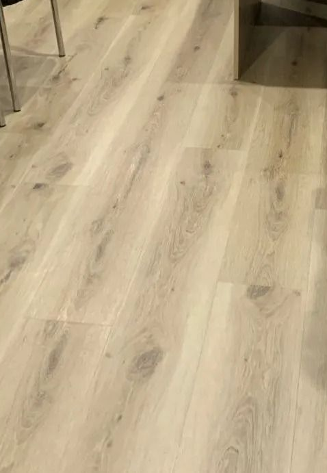 Light-coloured wood flooring with wood grain details in a bright room. — Ozwide Flooring In Ciccone, NT