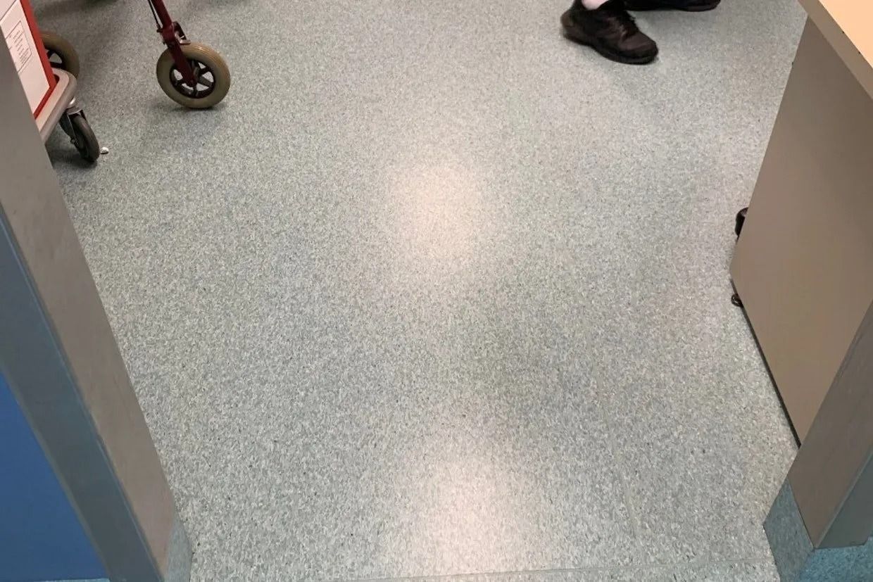 Floor With a Speckled Light Blue Pattern, Medical Setting With a Walker and Feet — Ozwide Flooring In Ciccone, NT
