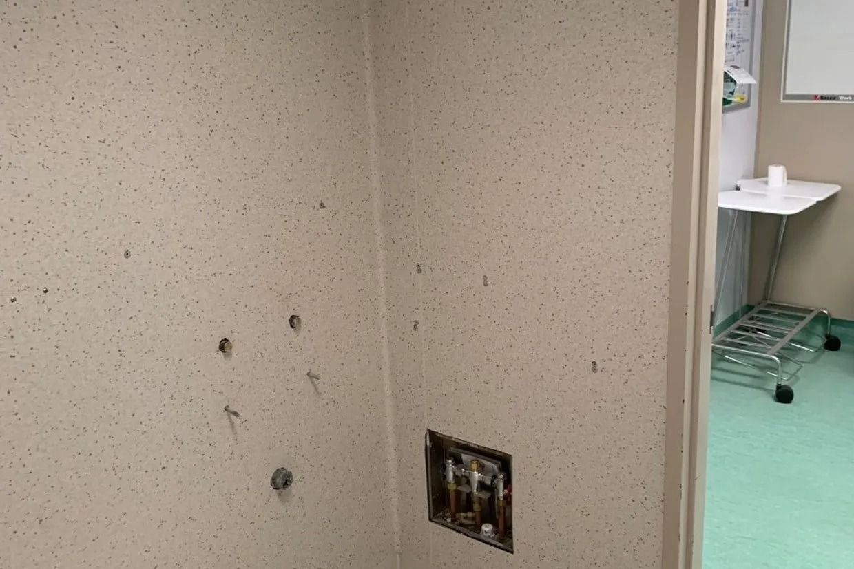 Interior View of a Beige Wall With Multiple Holes — Ozwide Flooring In Ciccone, NT