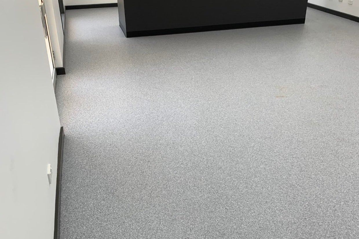 Grey Speckled Flooring in an Office, With White Walls and a Dark Grey Cabinet — Ozwide Flooring In Ciccone, NT