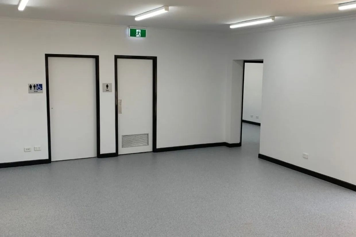 Empty White Room With Grey Floor — Ozwide Flooring In Ciccone, NT
