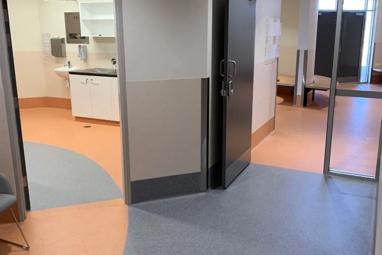 Hospital Hallway With Open Doorway to a Room — Ozwide Flooring In Ciccone, NT
