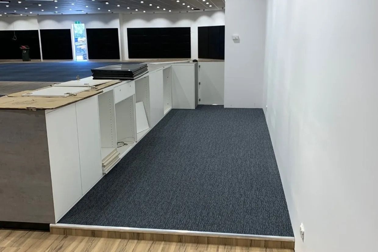 Interior With New Carpet, Counter, White Walls, and a Large Open Space — Ozwide Flooring In Ciccone, NT