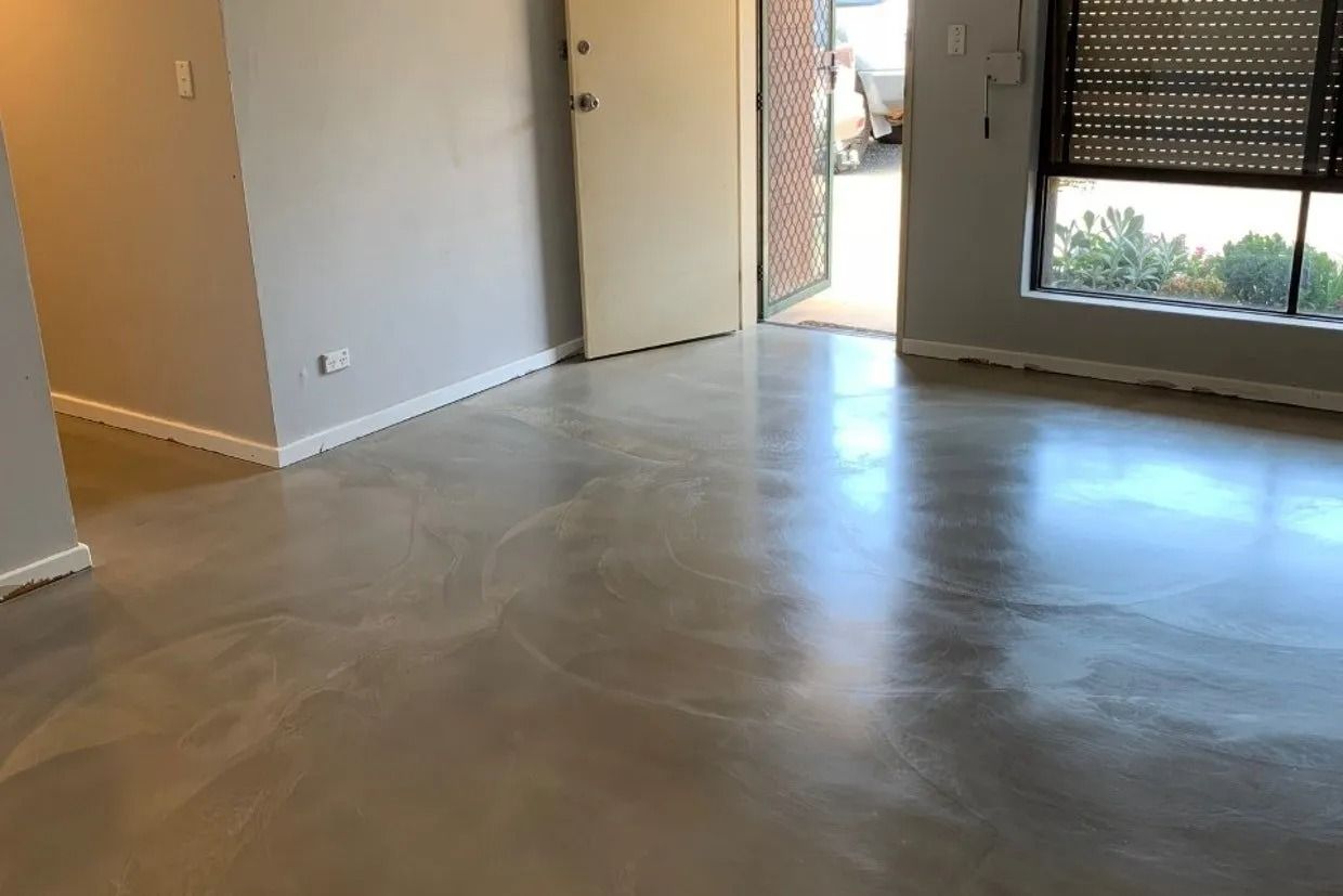 Glossy Grey Floor in a Room With Light Grey Walls — Ozwide Flooring In Ciccone, NT