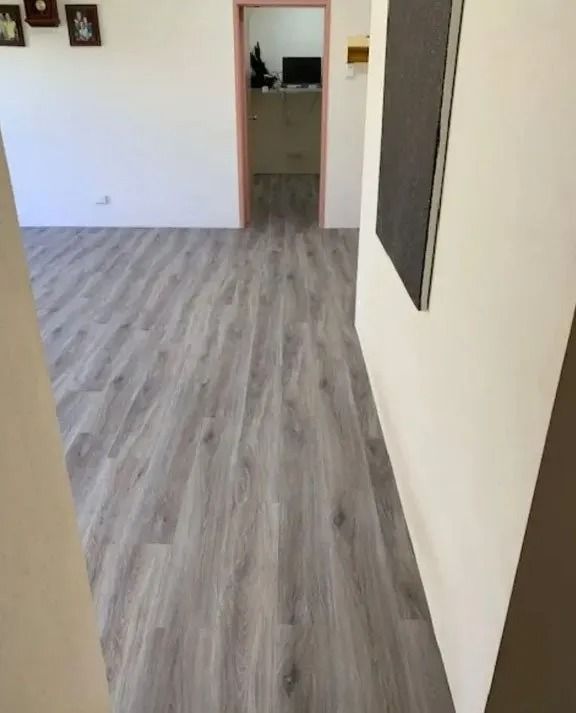Grey Wood-look Flooring Extends From the Foreground to a Doorway — Ozwide Flooring In Ciccone, NT