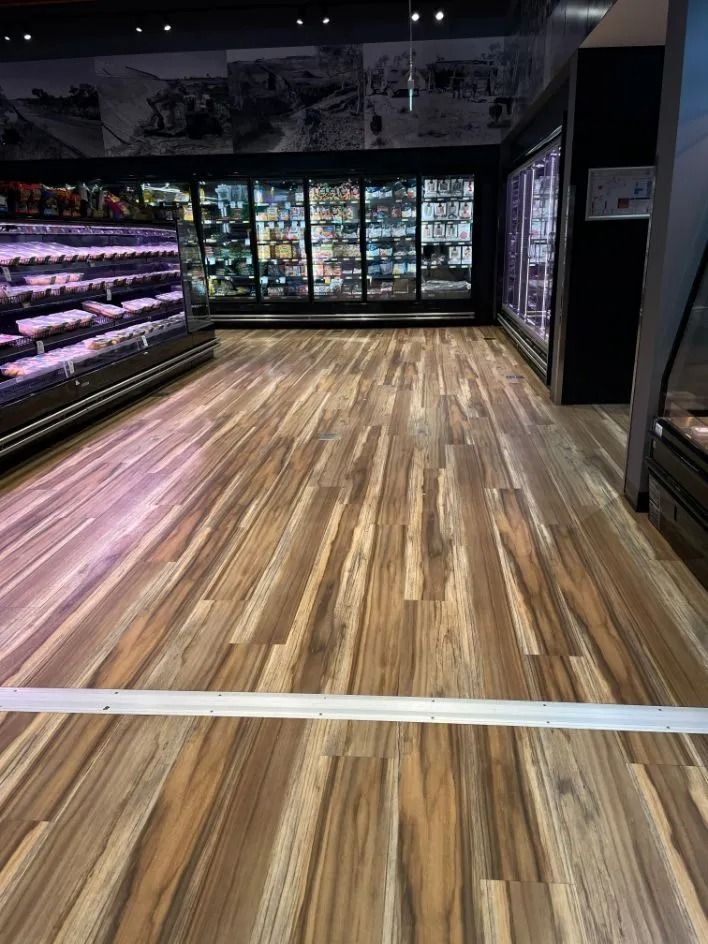 Wooden Floor in a Grocery Store Aisle With Refrigerated Display Cases — Ozwide Flooring In Ciccone, NT