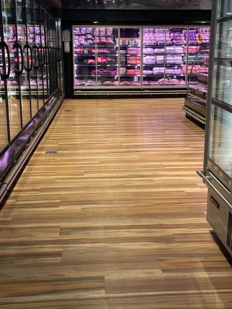 Wooden Floor Aisle in a Supermarket With Refrigerated Display Cases Filled — Ozwide Flooring In Ciccone, NT