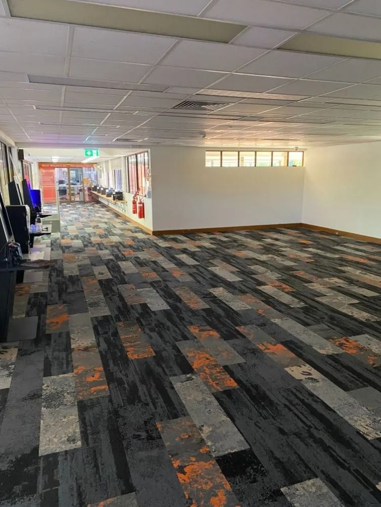 Interior of a Venue With Patterned Carpet, a White Wall, and a View Into a Hallway — Ozwide Flooring In Ciccone, NT