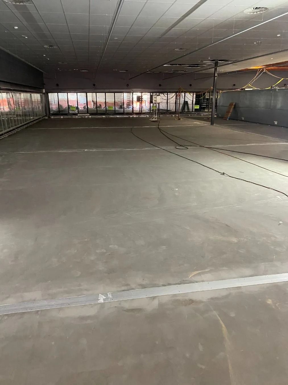 Empty Concrete Floor in Large Commercial Space — Ozwide Flooring In Ciccone, NT