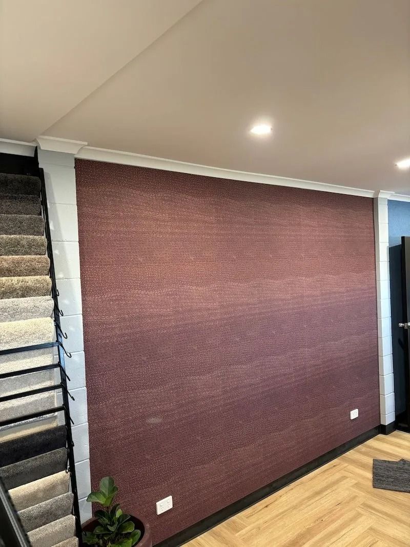 A Wall With Textured Maroon Finish, Bordered by White Trim — Ozwide Flooring In Ciccone, NT