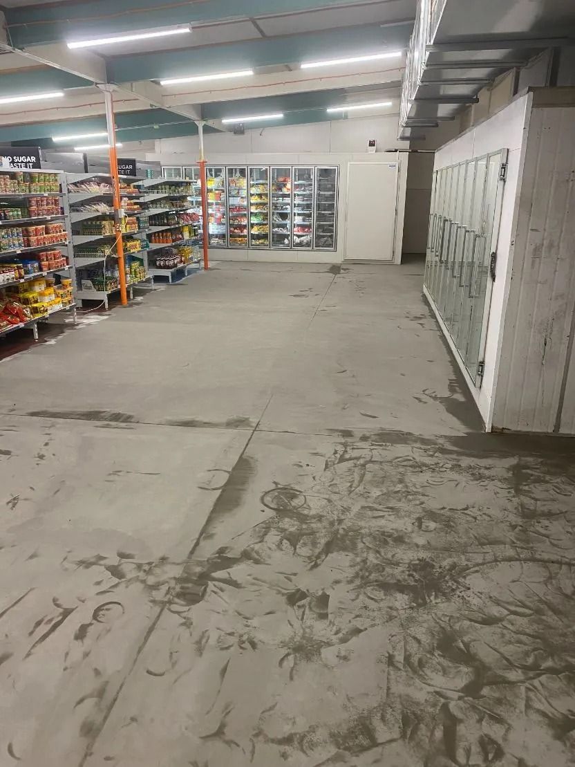 Grocery Store Interior With Wet Concrete Floor and Shelves of Products — Ozwide Flooring In Ciccone, NT