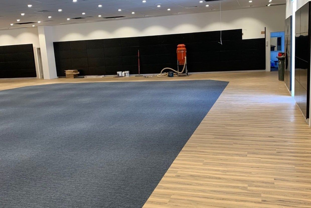 An Empty Commercial Space With Blue Carpet — Ozwide Flooring In Tennant Creek, NT