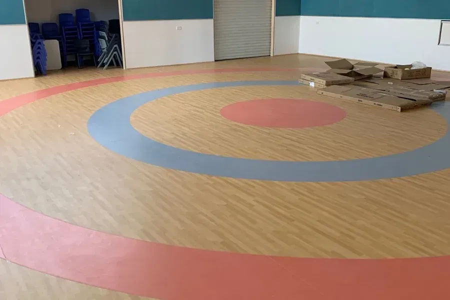 Wooden Floor With Concentric Circles in Red, Blue, and Pink — Ozwide Flooring In Ciccone, NT