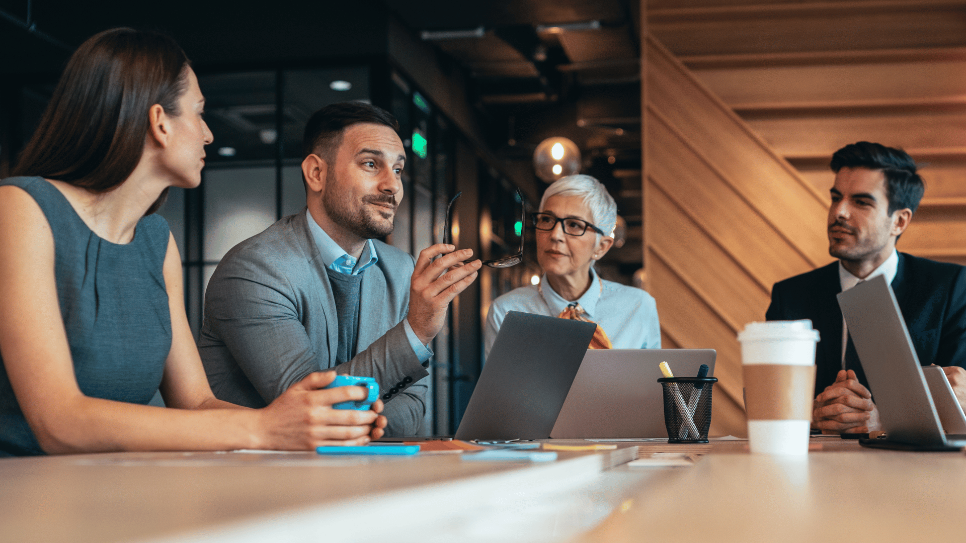 Campus administration at a table discussing smart parking strategies.