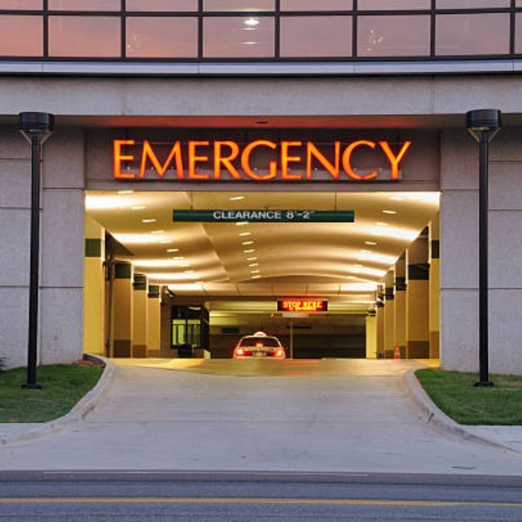 An emergency entrance to a hospital with a car in it