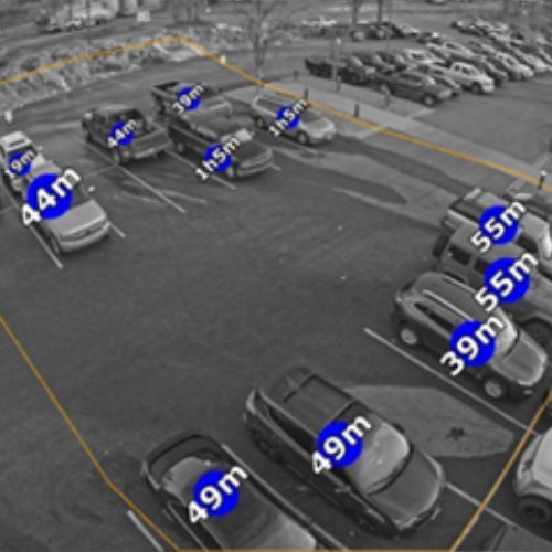 A black and white photo of a parking lot with cars labeled 44m and 49m