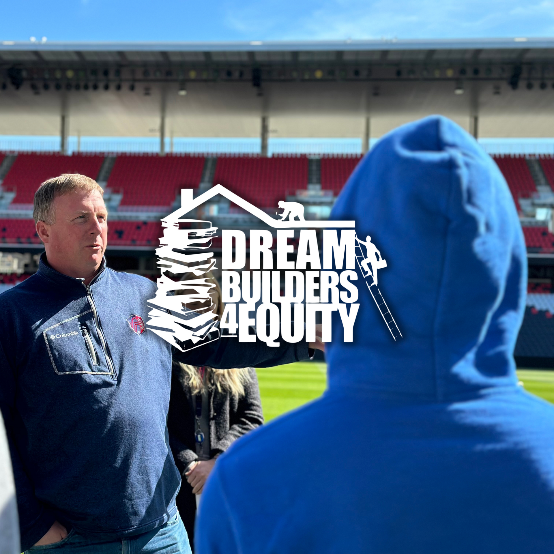 A man in a blue hoodie stands in front of a dream builders equity logo