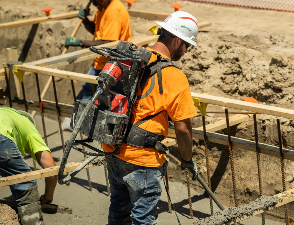 A group of construction workers are working on a construction site.