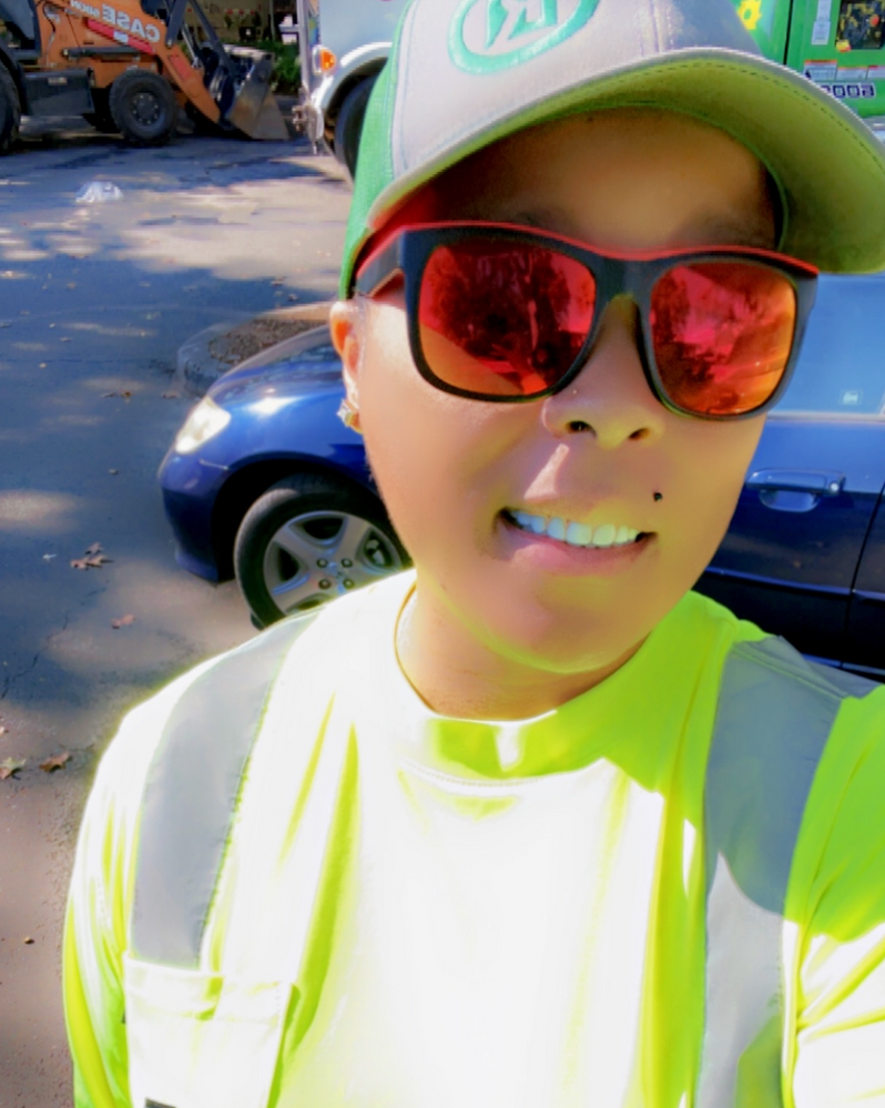 A man wearing sunglasses and a hat is taking a selfie